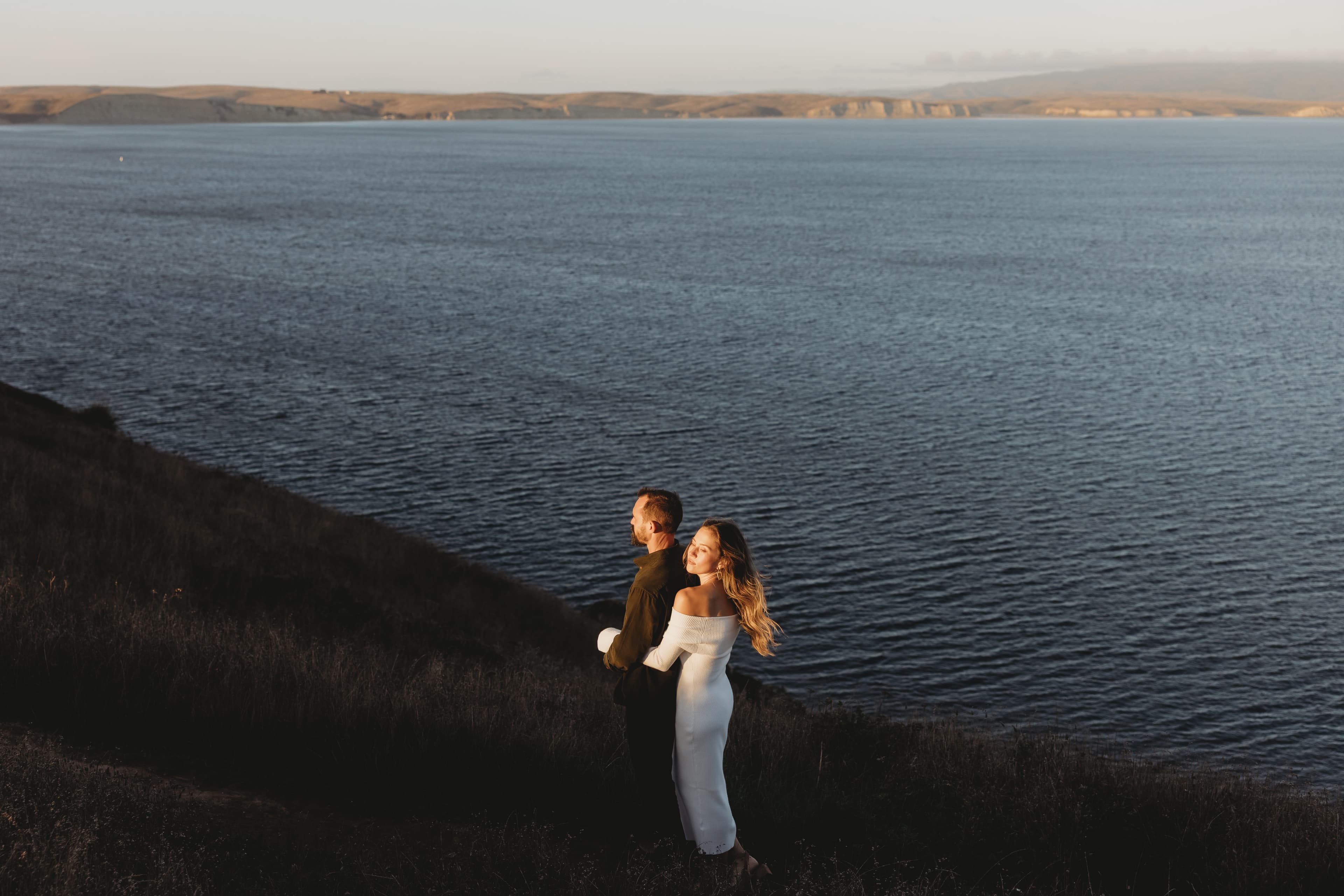 Rob & Lindsay overlooking the water at golden hour